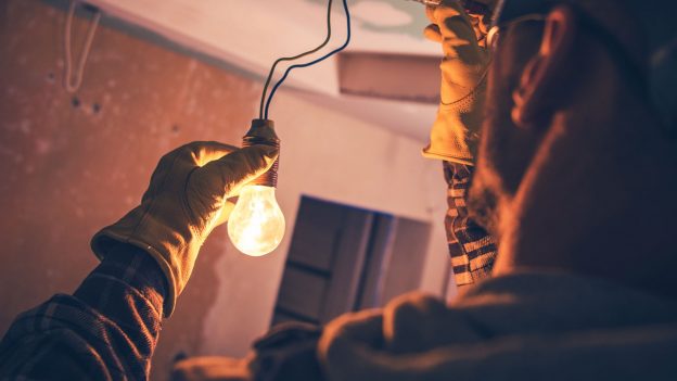 Electrician holding a bulb