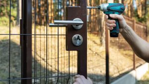 Contractor drilling a fence