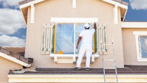 Contractor working on house facade