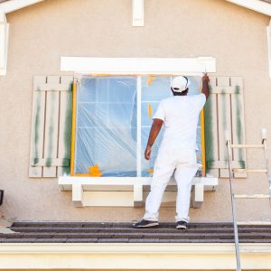 Contractor working on house facade