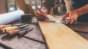 Contractor working on wooden plank