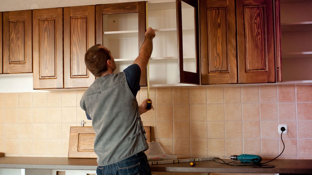 Image of a contractor working on a cabinet