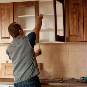 Image of a contractor working on a cabinet