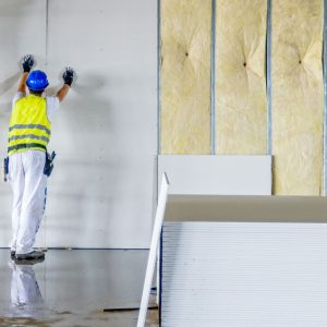 Contractor installing drywall