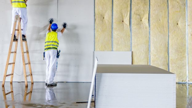 Contractor installing drywall