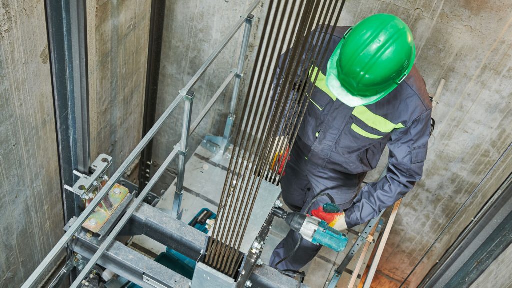 Image of a contractor working in elevator shaft