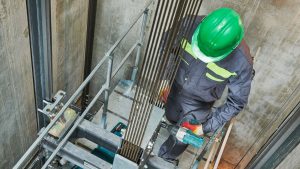 Image of a contractor working in elevator shaft