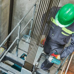 Image of a contractor working in elevator shaft