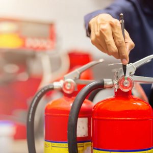 Image of a contractor working on fire extinguisher