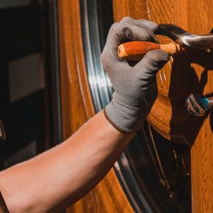 Image of a contractor working on a lock of a door