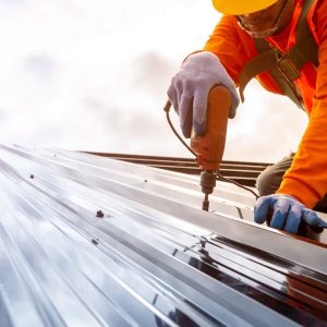 Image of a contractor working on a metal sheet