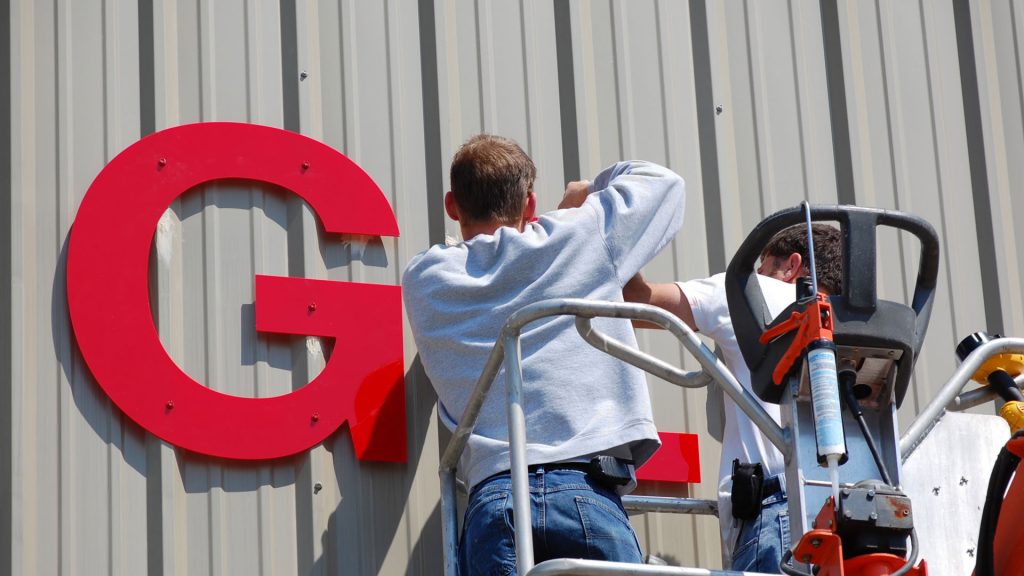 Image of a contractor working on a electric sign