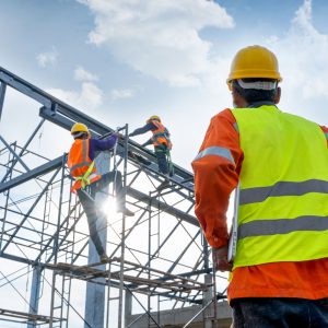 Image of a contractor looking at a structure made of steel