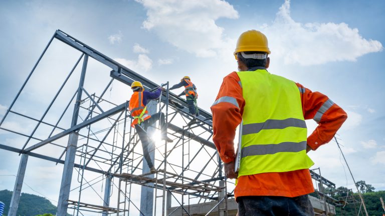 Image of a contractor looking at a structure made of steel