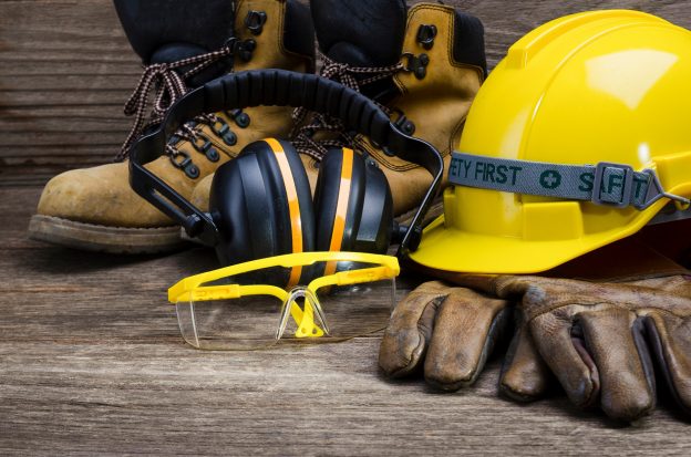 Image of contractor boots, helmet, gloves and ear protection